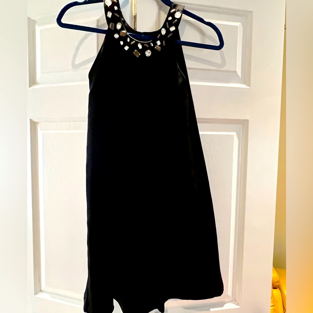 Sleeveless black dress with a high/ mock neckline. Soft fabric and comfortable.